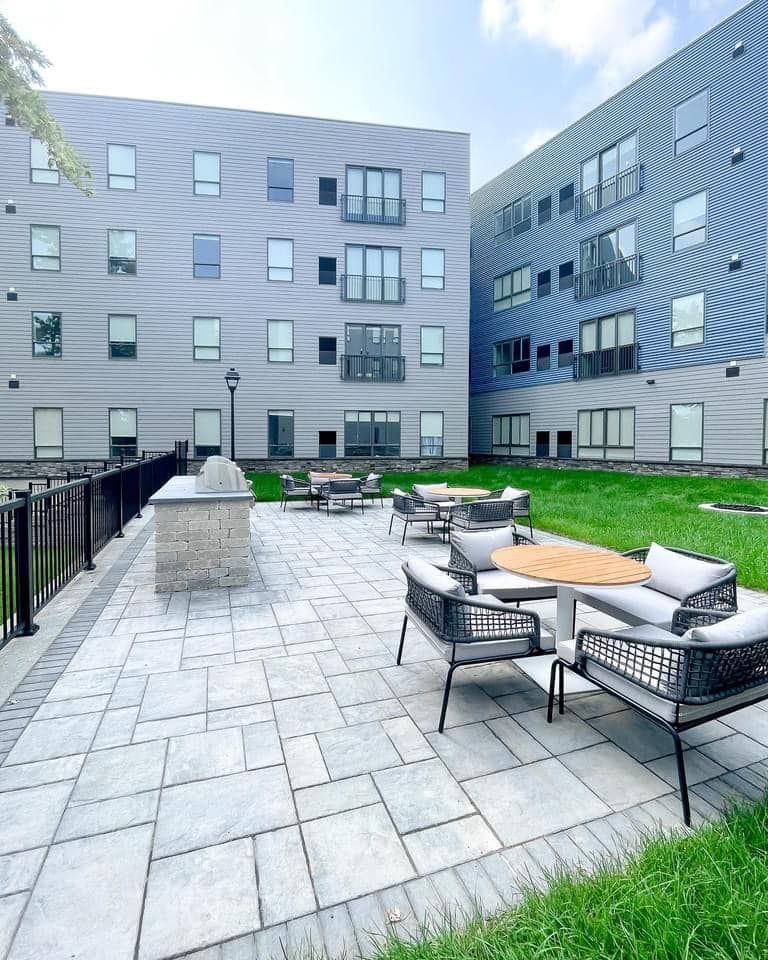 A large building with a patio in front of it.