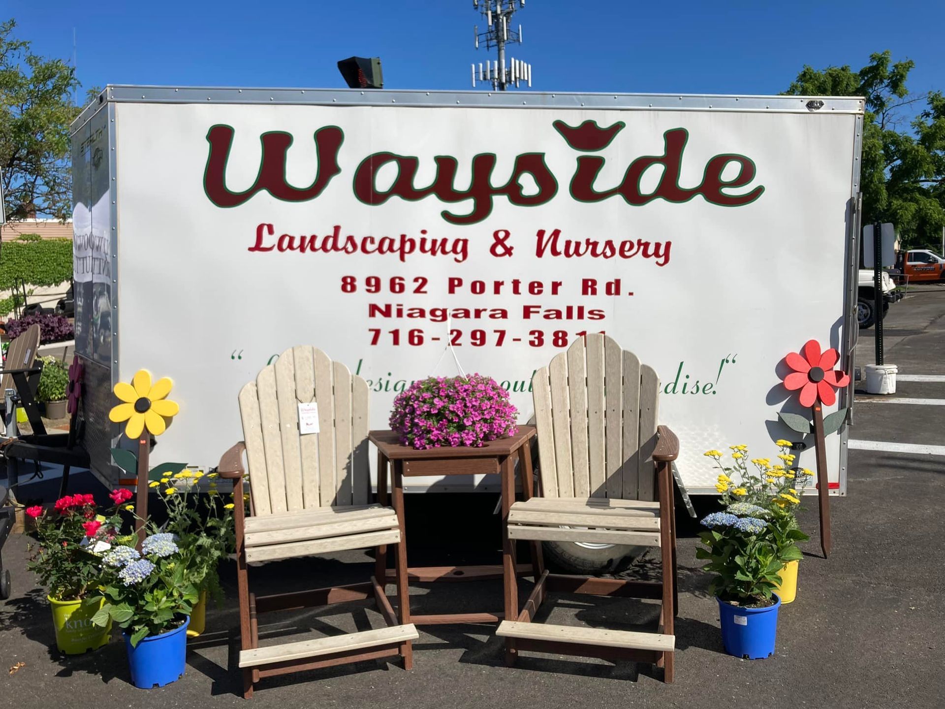 A wayside landscaping and nursery trailer is parked in a parking lot