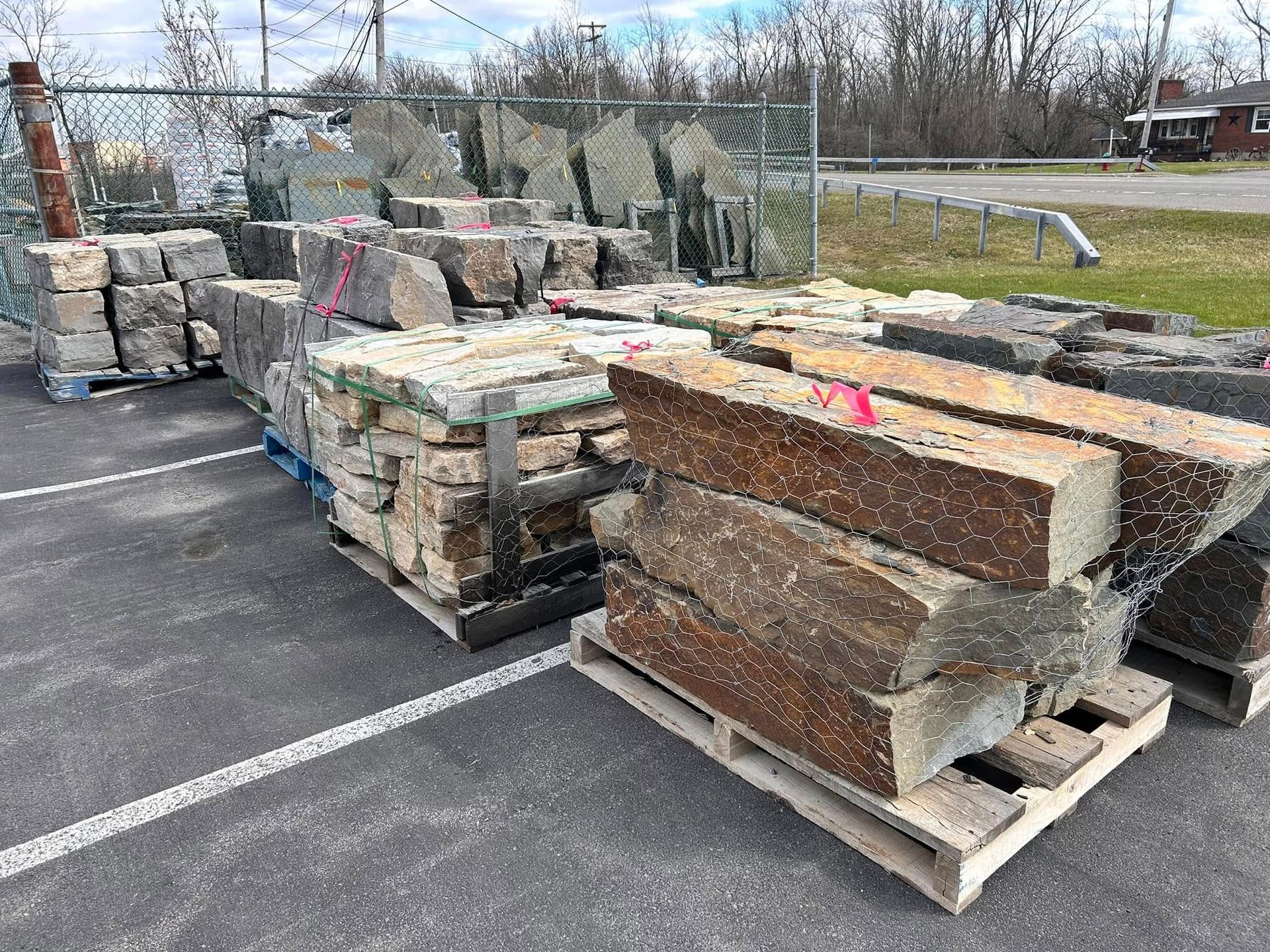 A pile of rocks sitting on top of a wooden pallet in a parking lot.