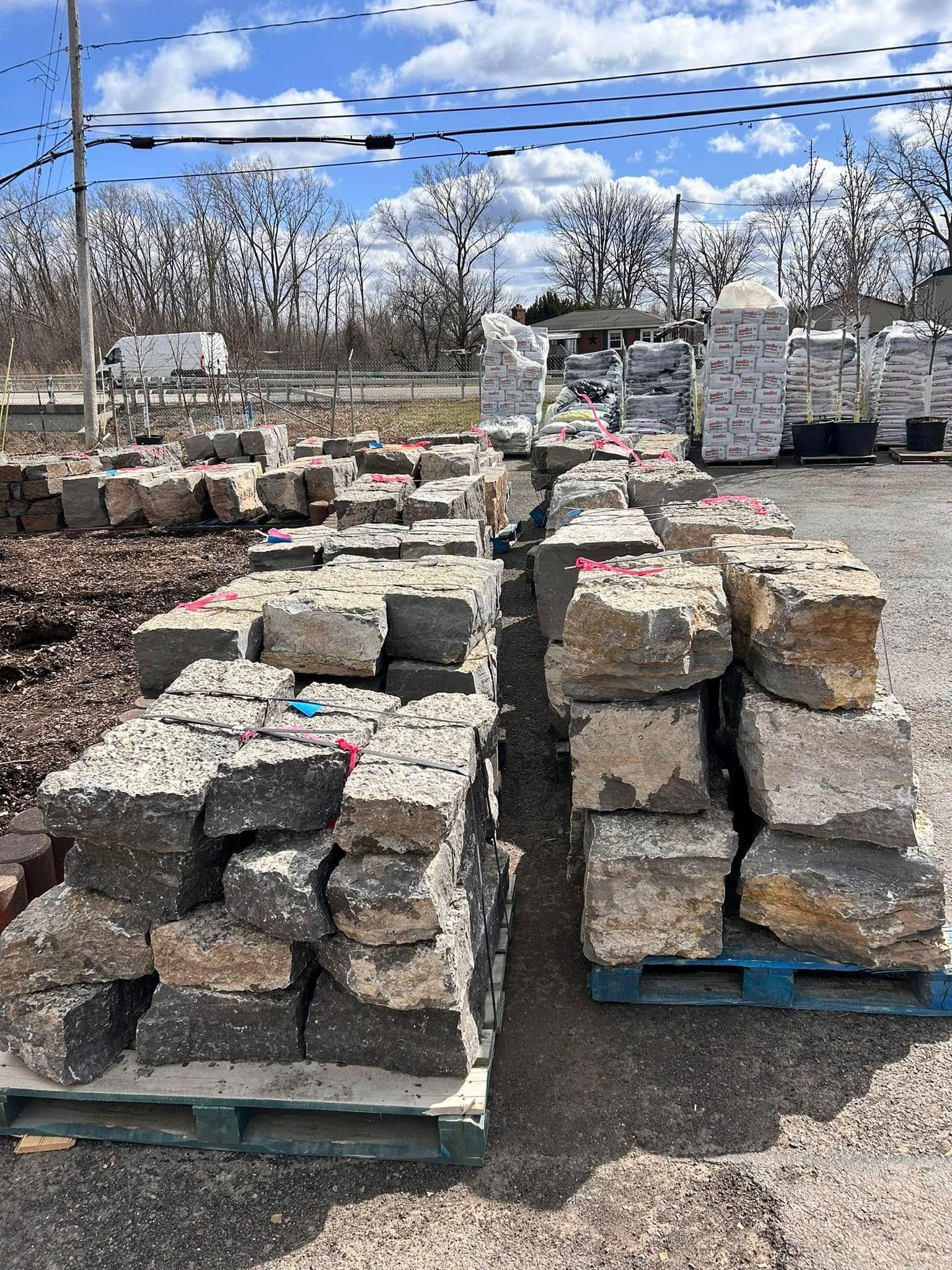 A bunch of bricks are stacked on top of each other on a pallet.