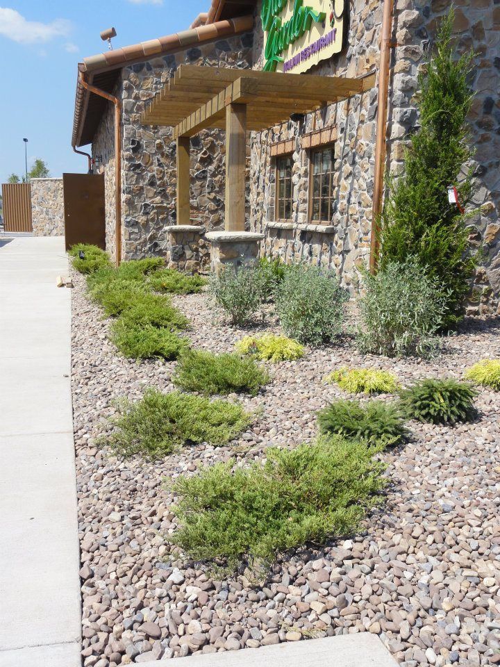 A stone building with a sign that says green kitchen