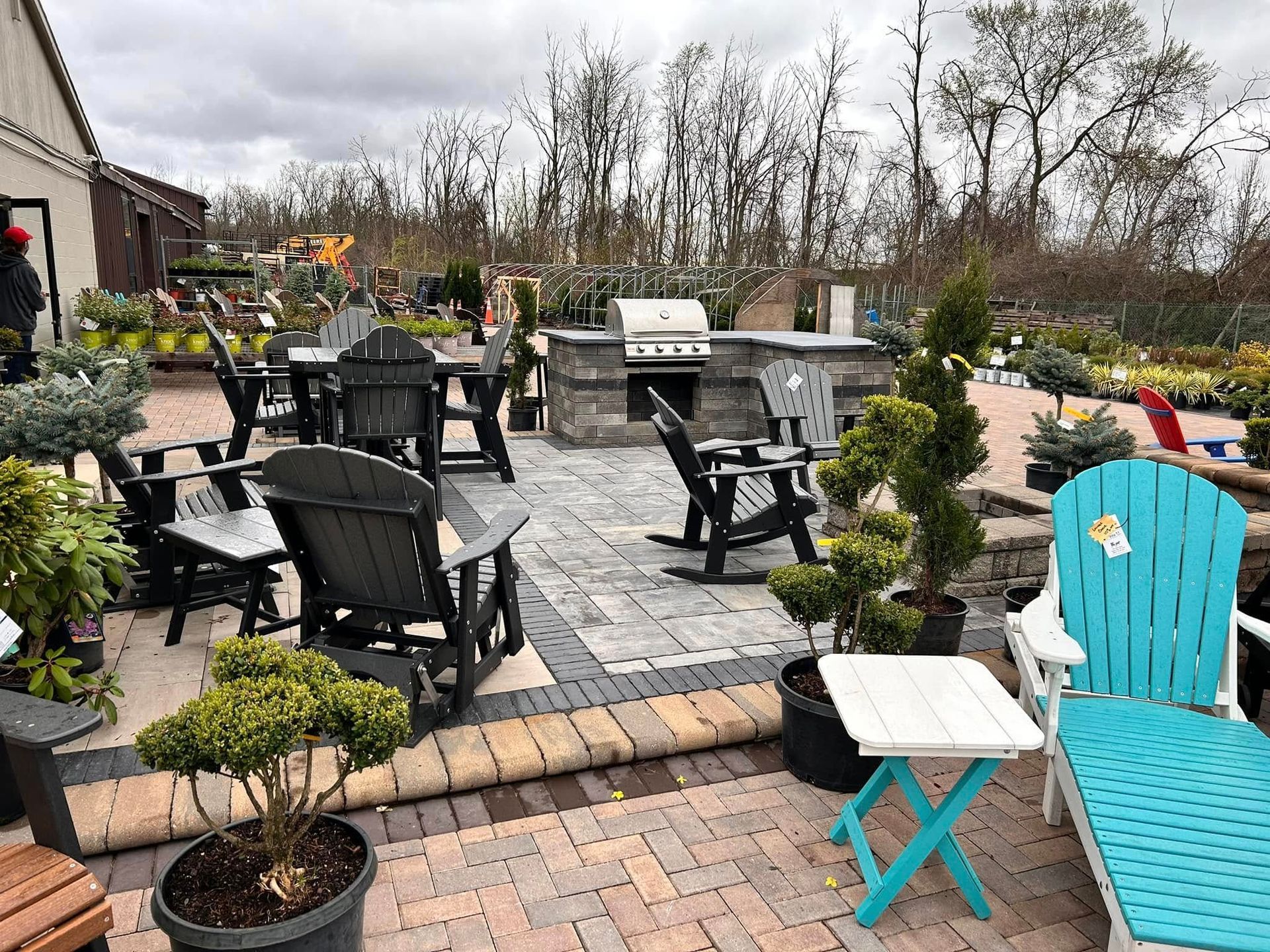 There are many chairs and tables on the patio.