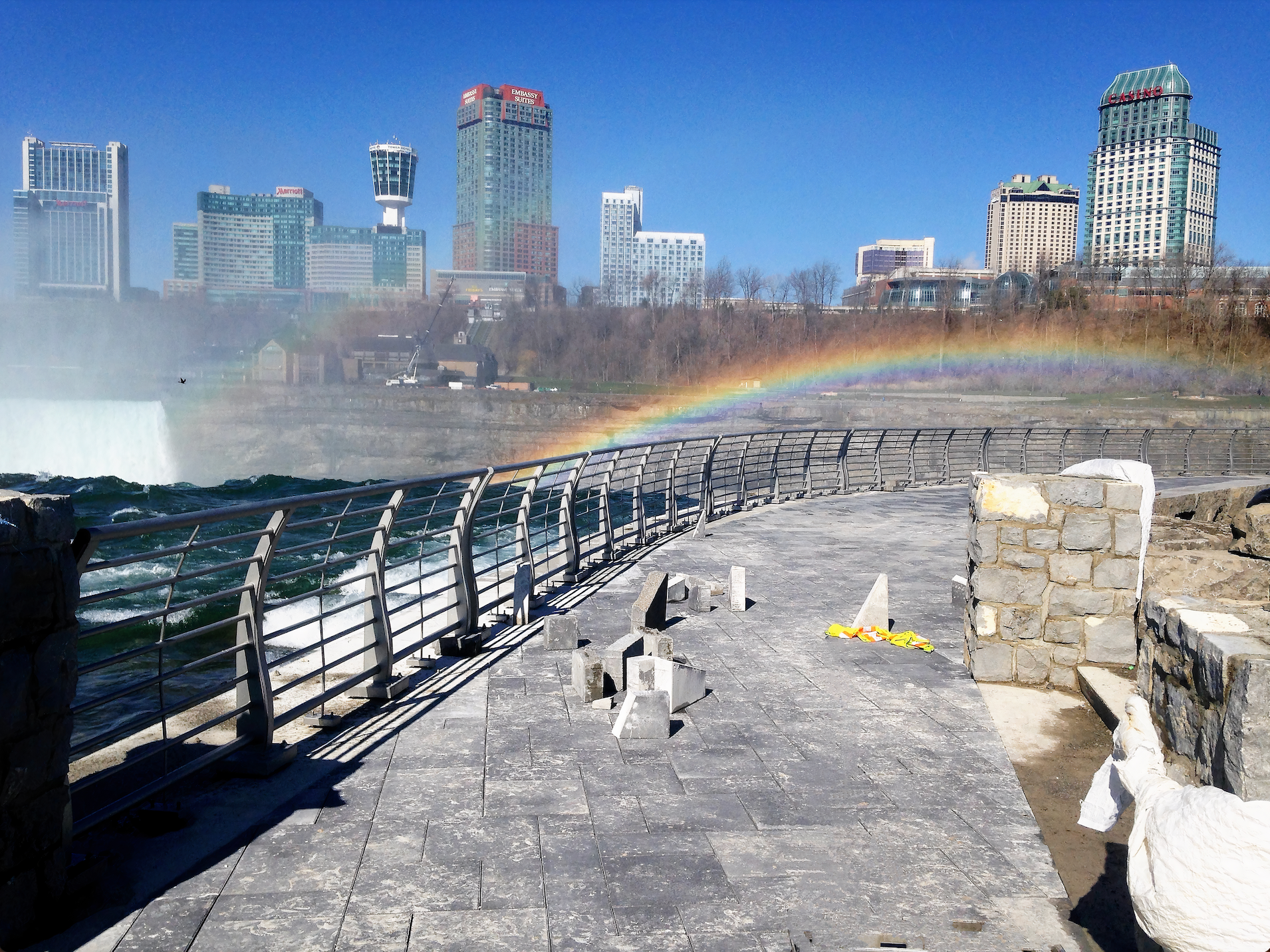 A rainbow is visible over a body of water
