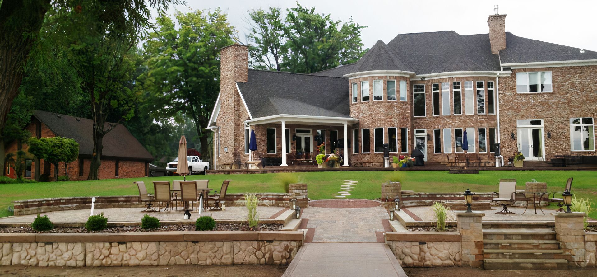 A large brick house with a dock in front of it