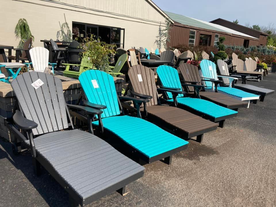 A bunch of chairs are lined up in front of a building