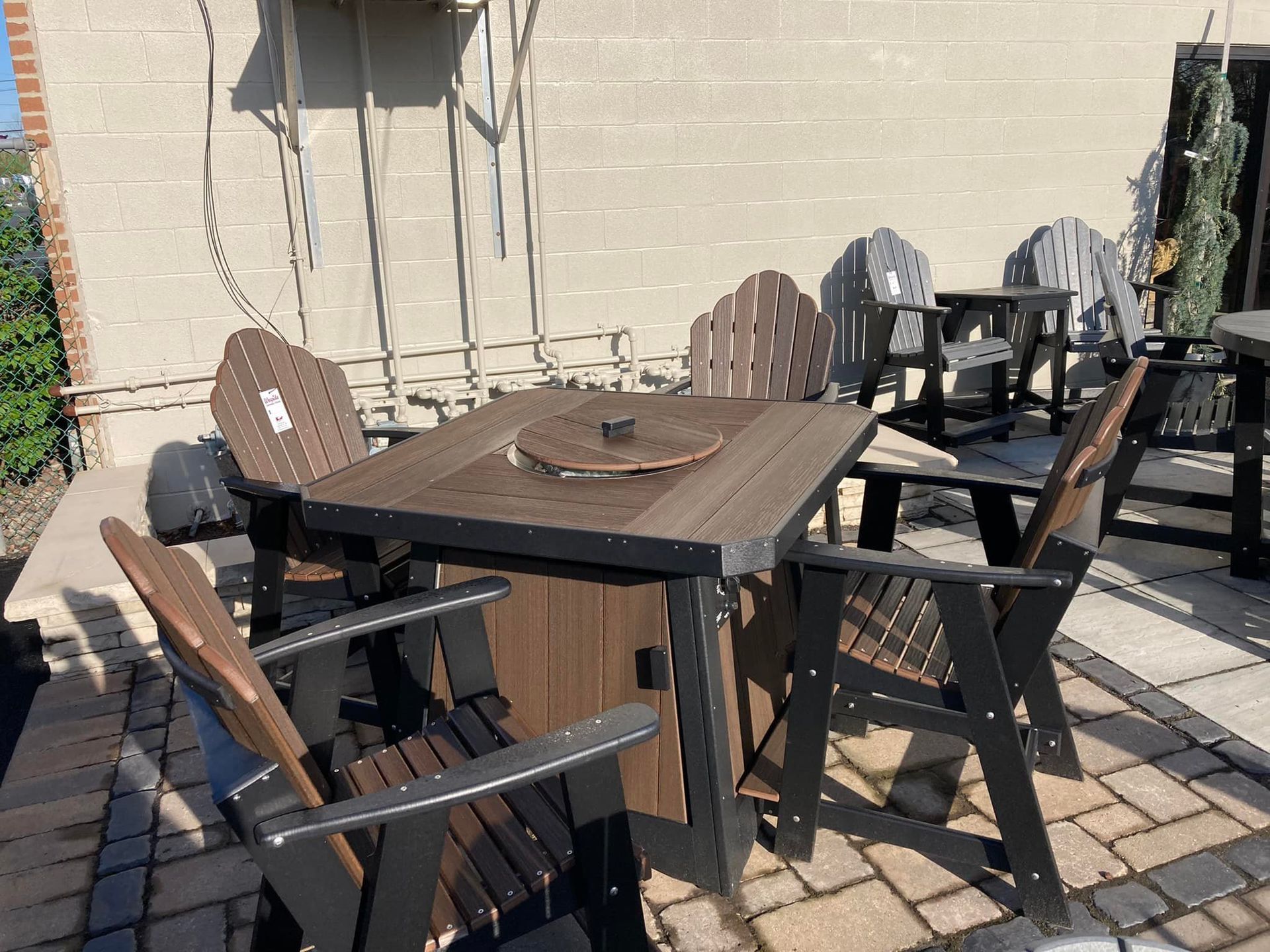 A table and chairs are sitting on a brick patio.