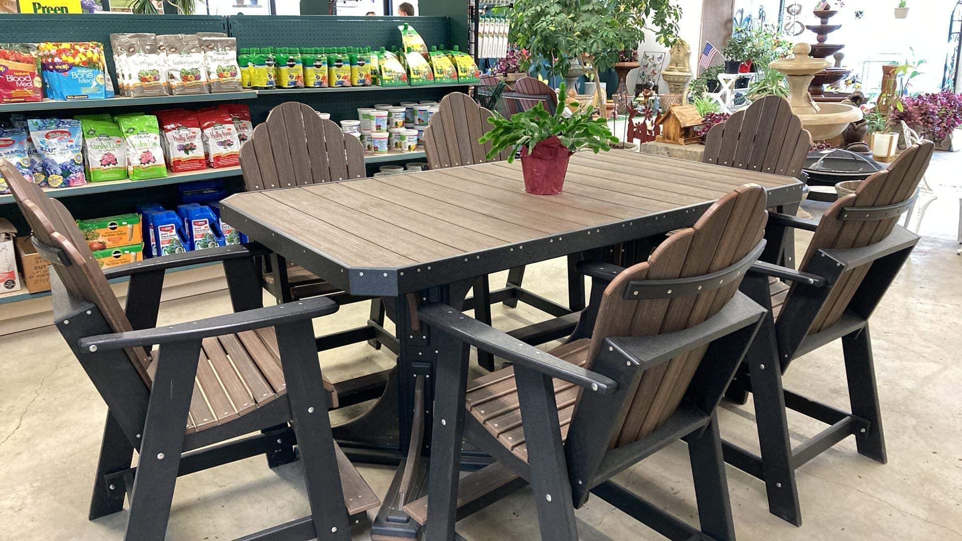 A table and chairs in a store with a potted plant on it.