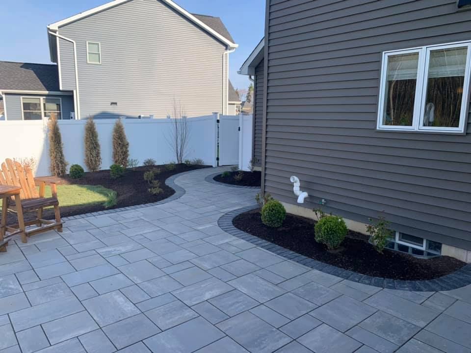 A patio with a table and chairs in front of a house.