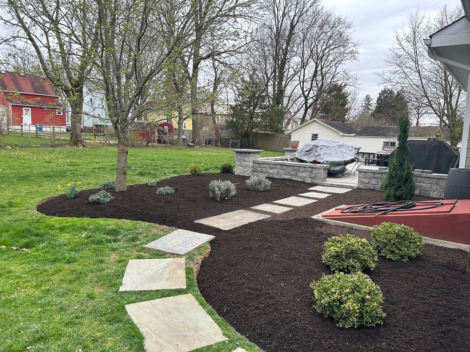 A lush green yard with a walkway leading to a house.