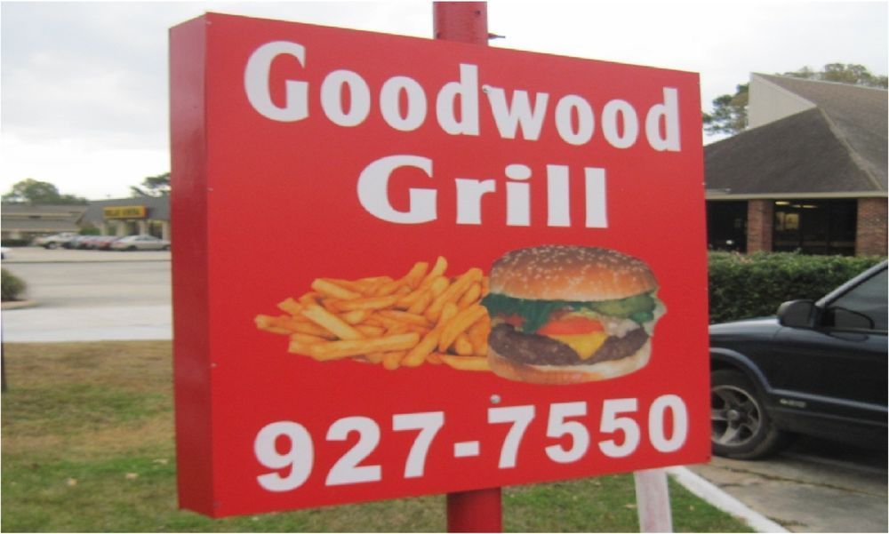 Red sign for Goodwood Grill restaurant with burger and fries illustration, phone number 927-7550.