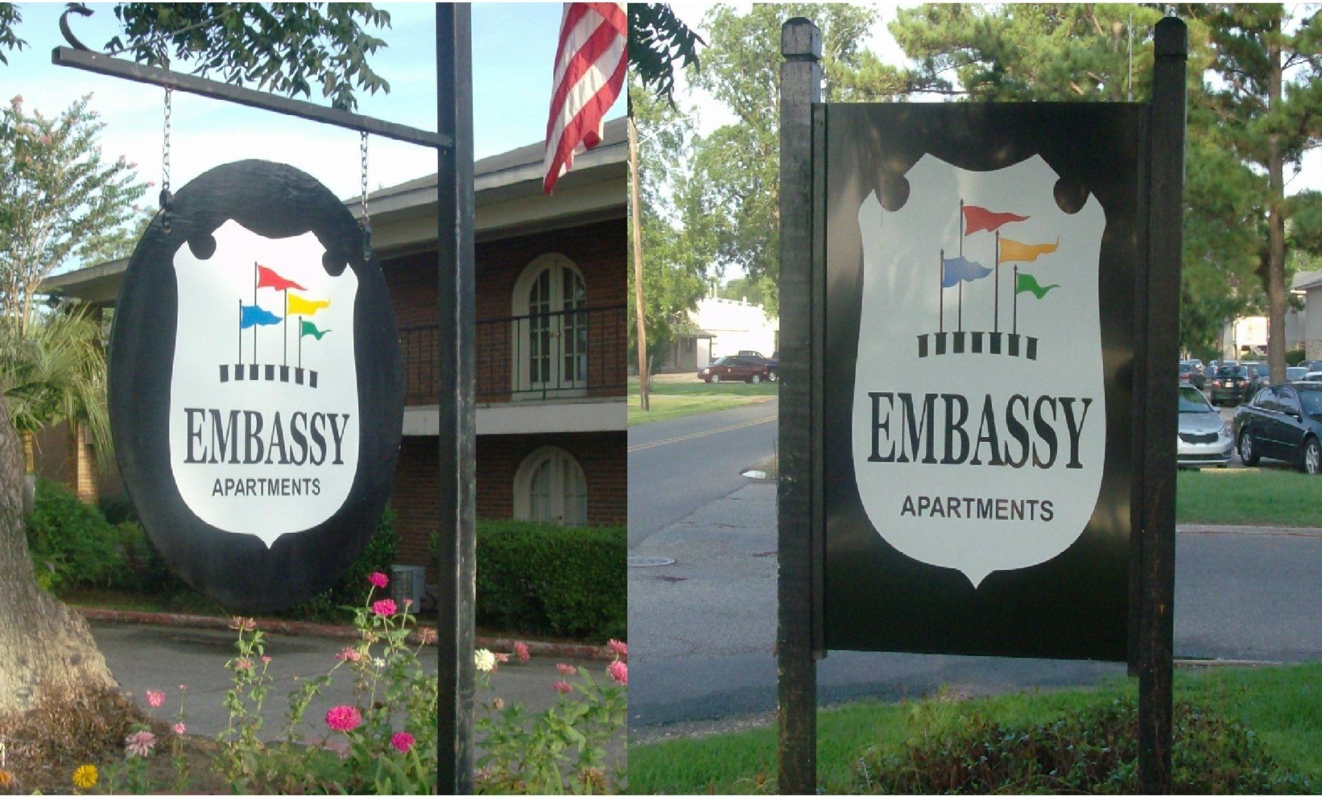 Two signs for Embassy Apartments: one oval and one rectangular, both with the same logo of a shield with colorful flags.