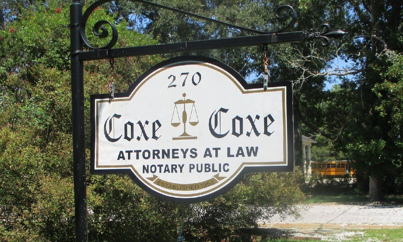 Sign for Coxe & Coxe Attorneys at Law and Notary Public, located at 270.  A stylized scale of justice emblem is between the firm's name.