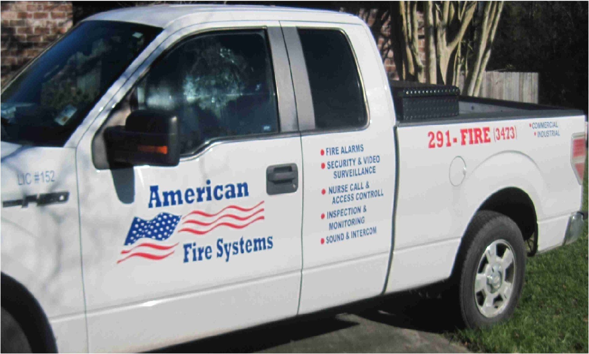 White American Fire Systems truck parked outdoors.