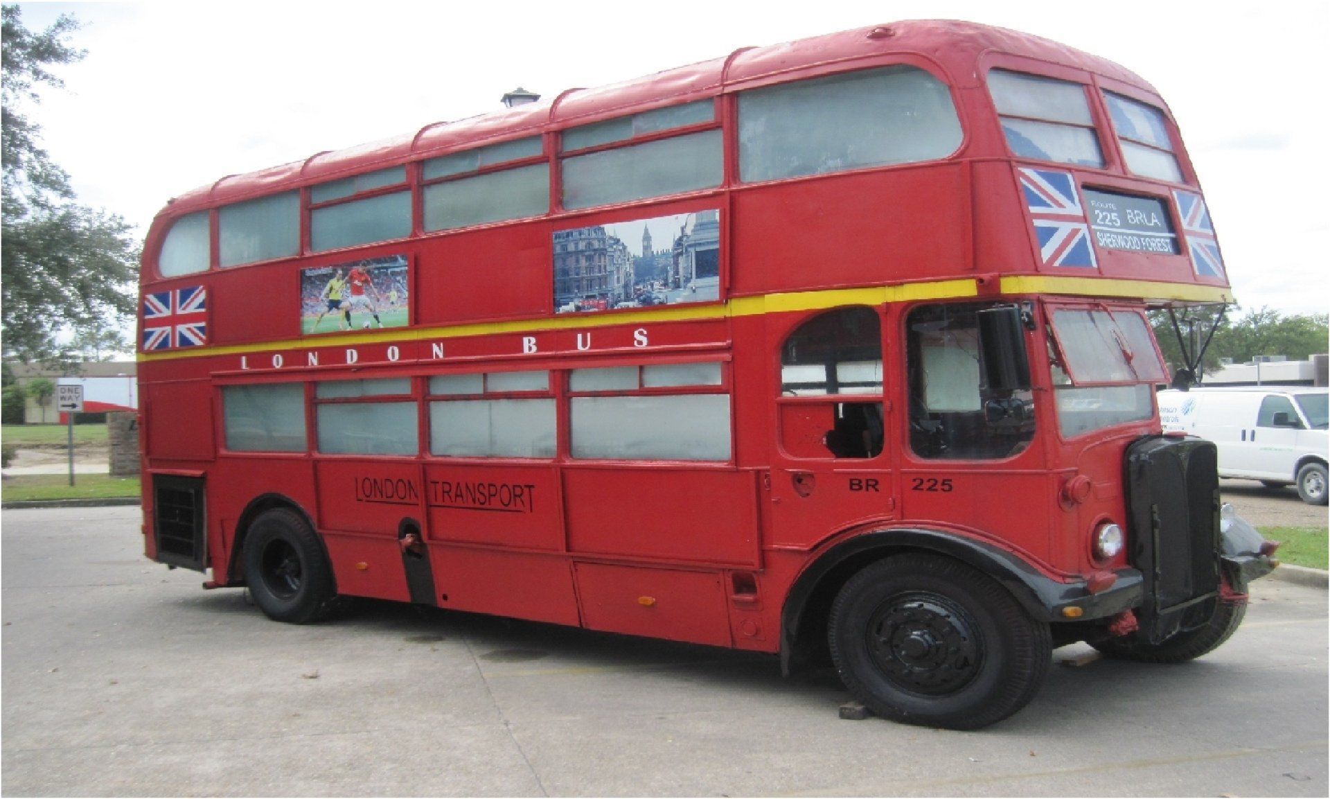 Red double-decker London bus with the Union Jack flags on the side.