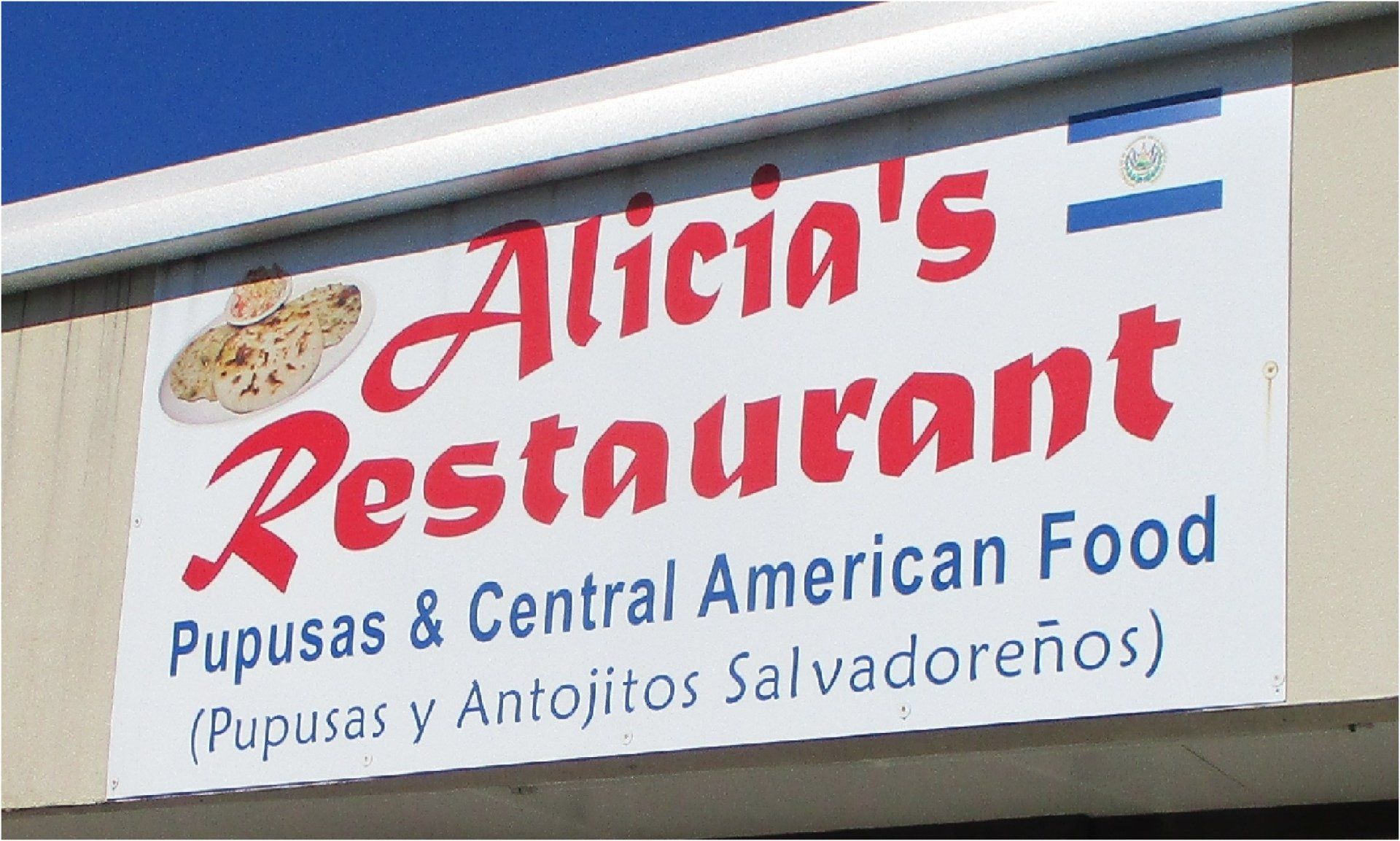Sign for Alicia's Restaurant featuring red text, a Salvadoran flag, and the words 