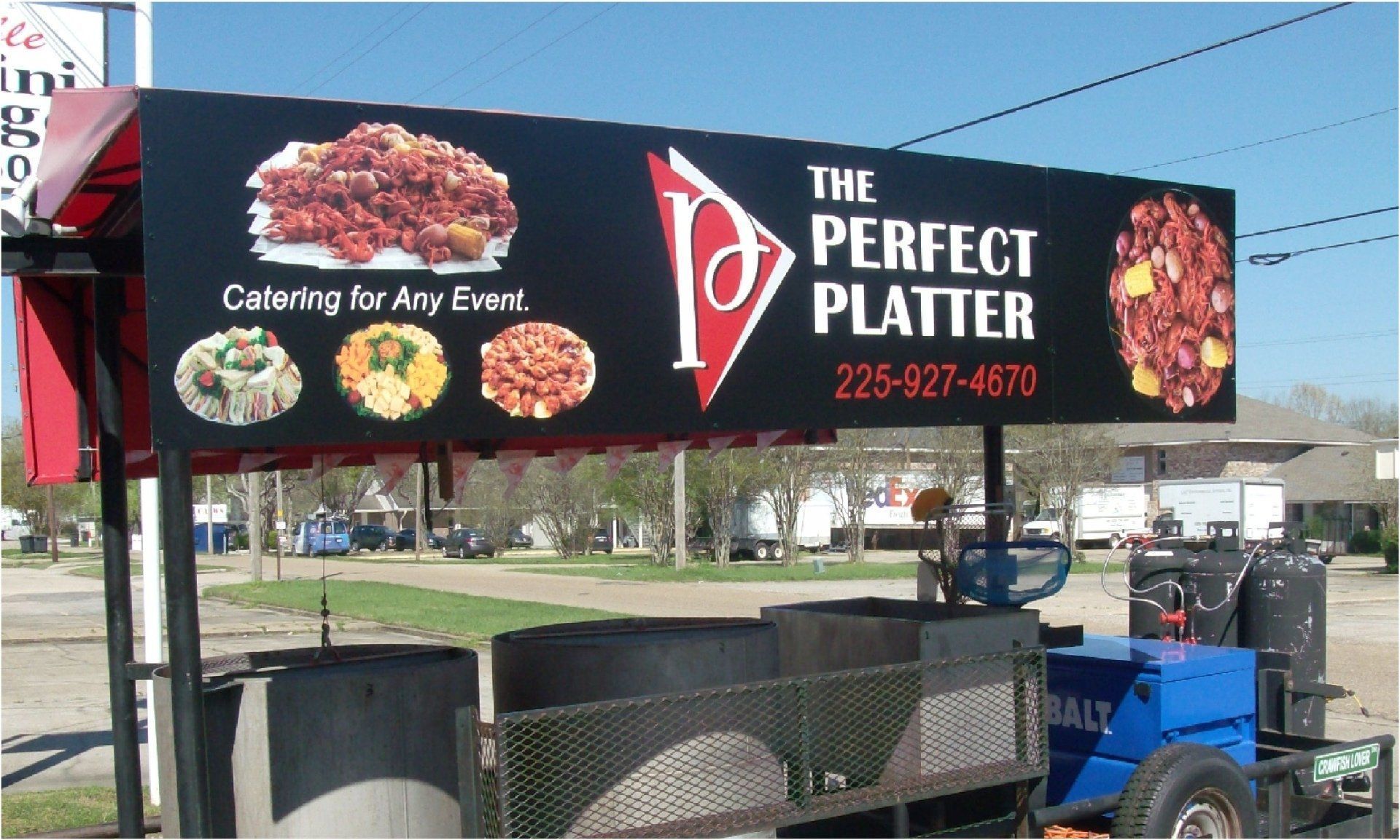 A food cart with a black sign that reads 