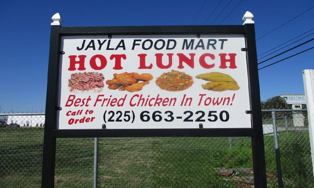 Sign for Jayla Food Mart advertising hot lunch and 