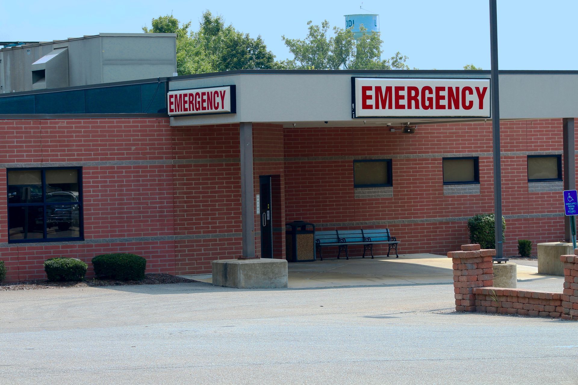 Emergency room entrance of a brick building with red 