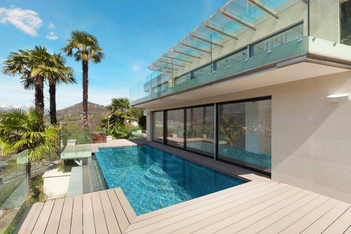 A large house with a swimming pool and palm trees