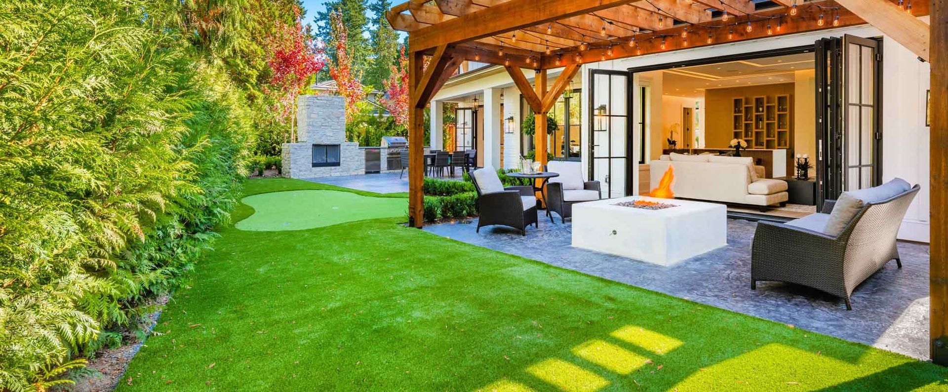 There is a fire pit in the backyard of a house.