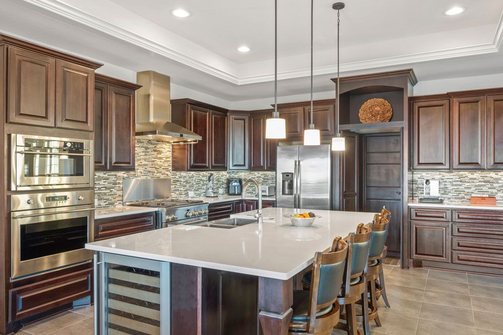 A large kitchen with stainless steel appliances and a large island.