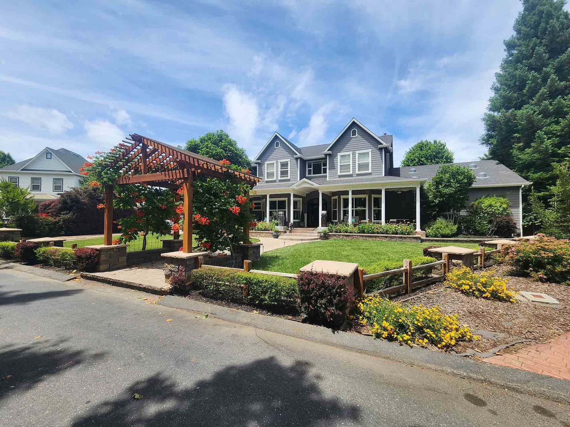 A large house with a pergola in front of it