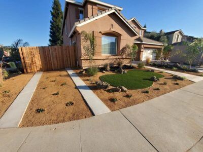 A house with a circular lawn in front of it