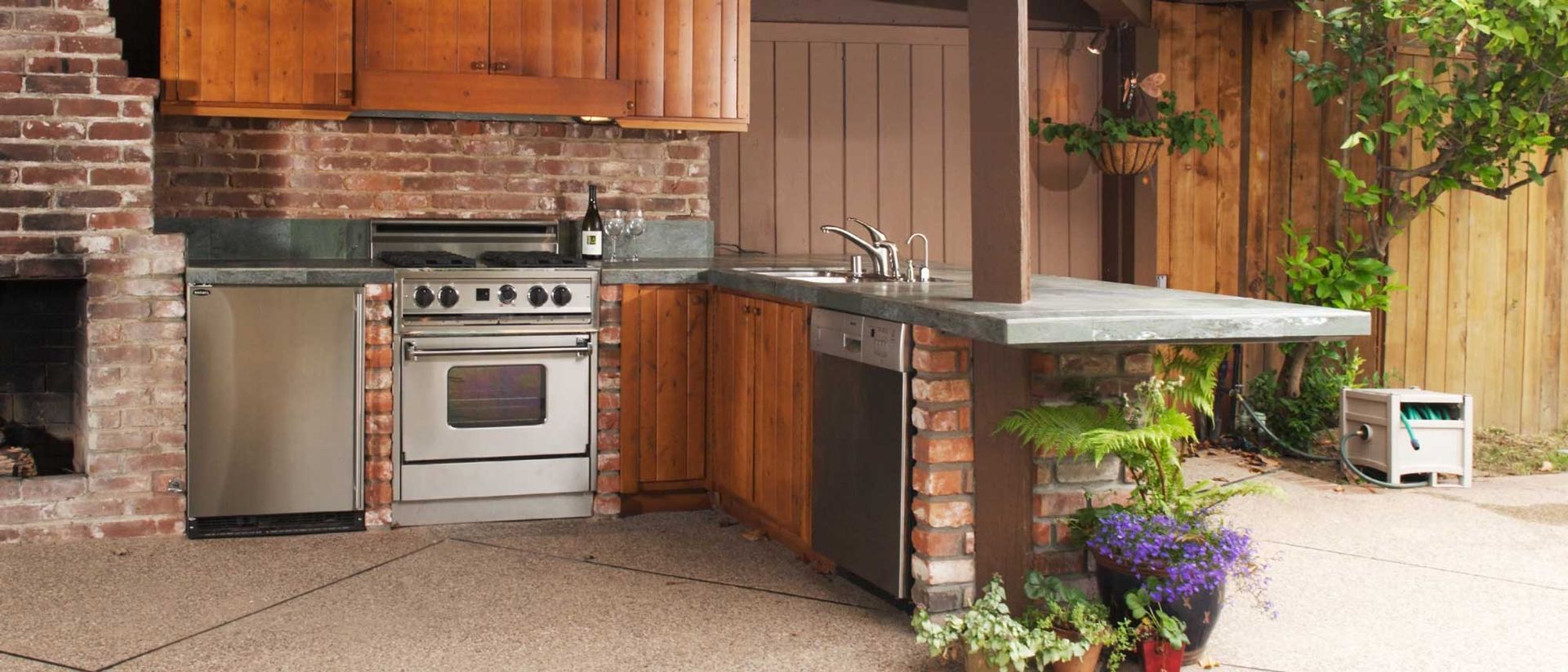 A kitchen with stainless steel appliances and wooden cabinets