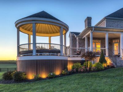 There is a gazebo in the backyard of a house.