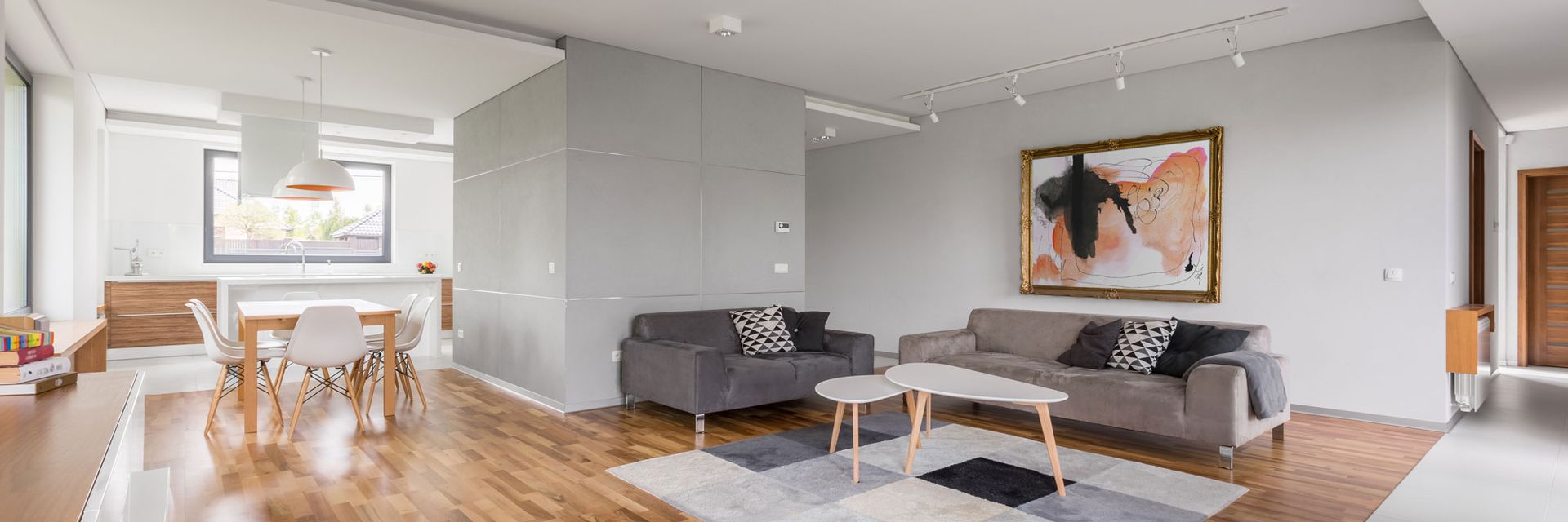 A living room filled with furniture and a painting on the wall.