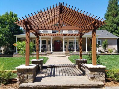 A house with a pergola in front of it