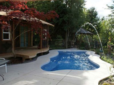 A small house with a swimming pool in the backyard