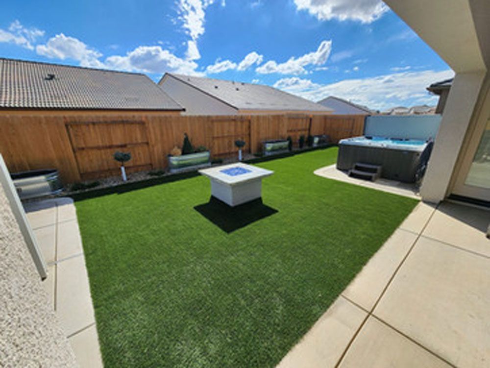 A backyard with a fire pit and a hot tub