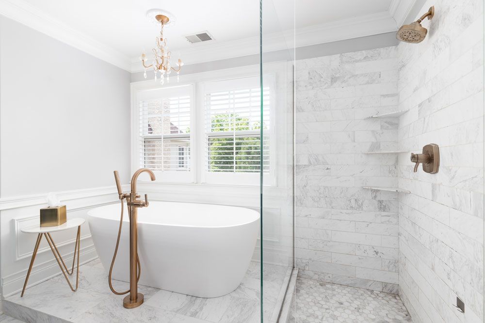 A bathroom with a bathtub and a walk in shower.