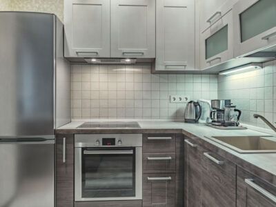 A kitchen with stainless steel appliances and wooden cabinets.