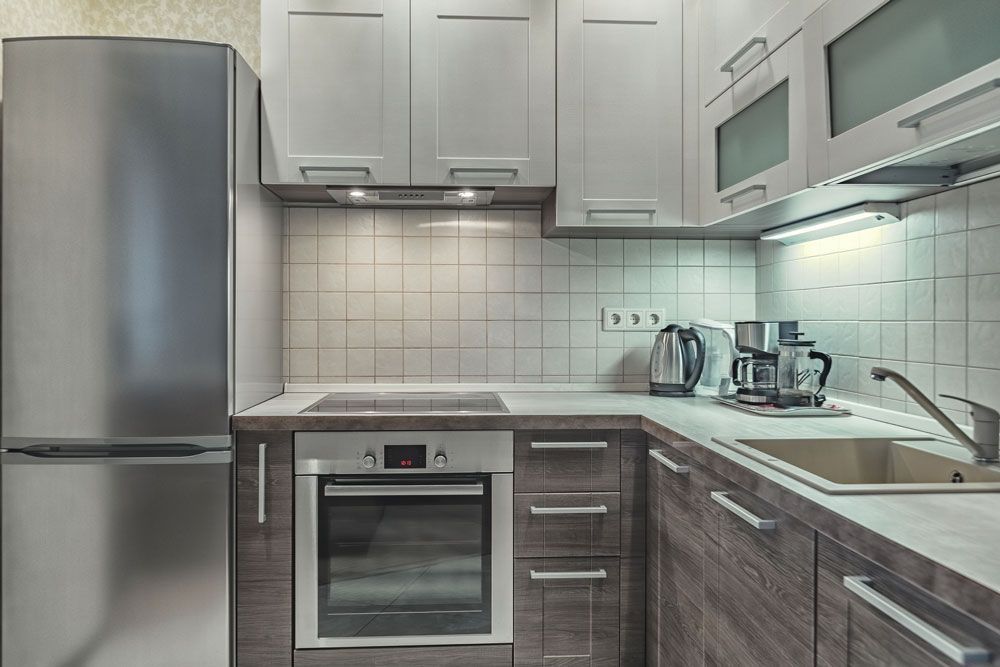 A kitchen with stainless steel appliances and wooden cabinets.