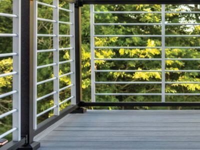 A balcony with a railing and trees in the background