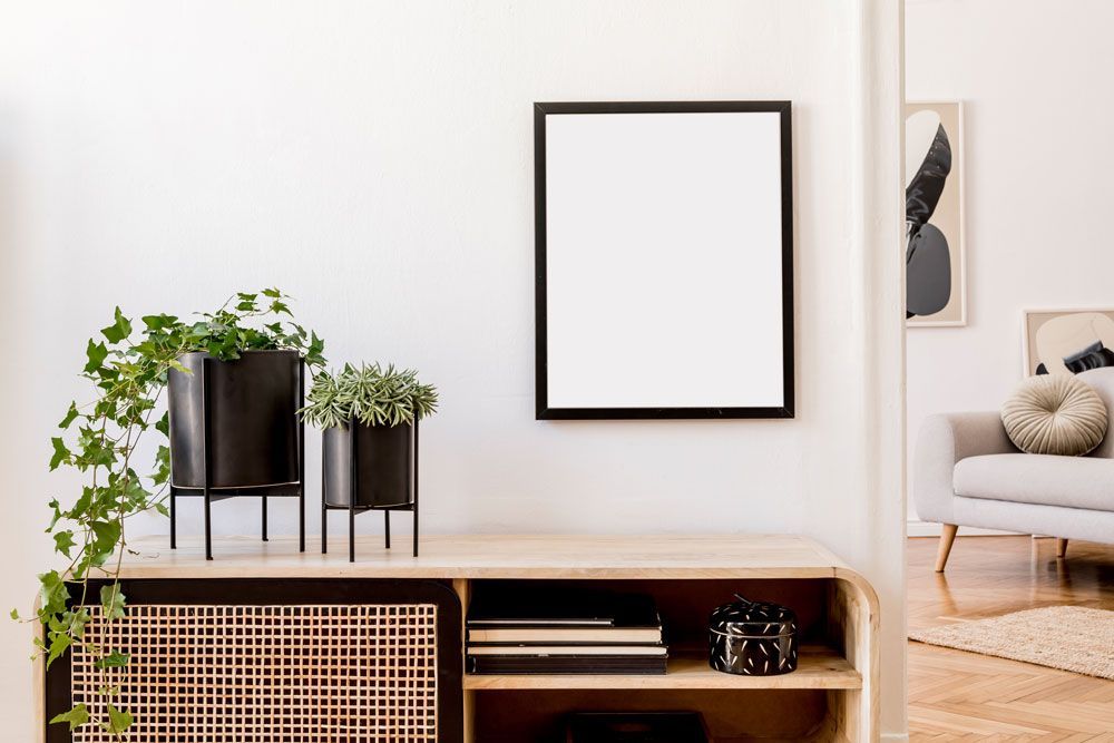 There is a picture frame hanging on the wall in the living room.