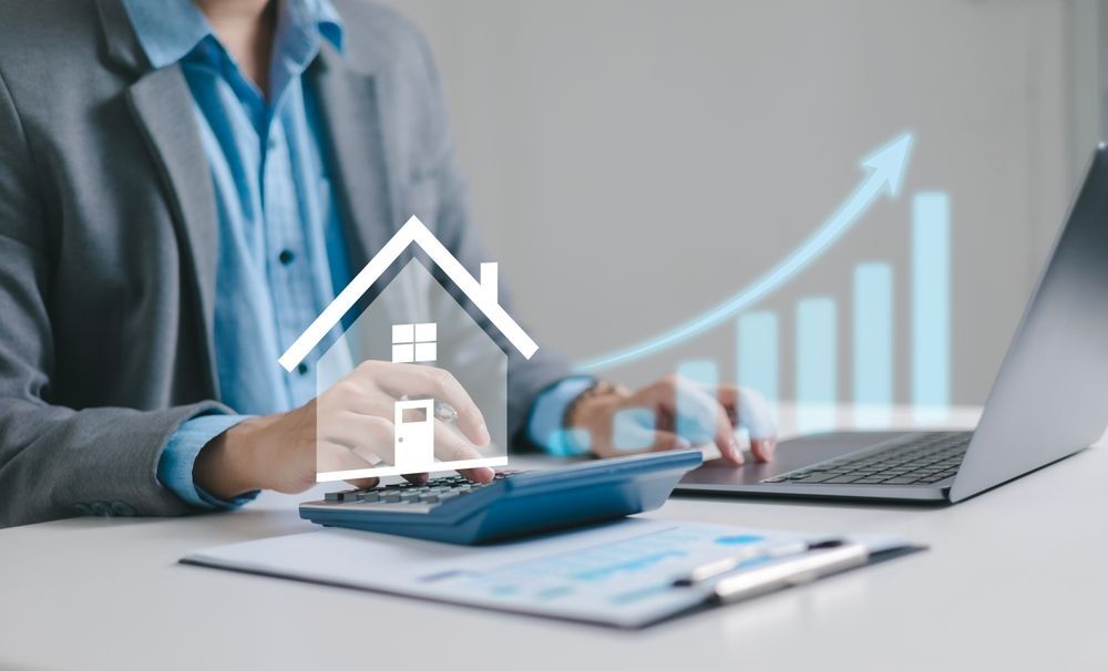 Businessman calculating his house value using a calculator, focused on financial assessment and decision-making.