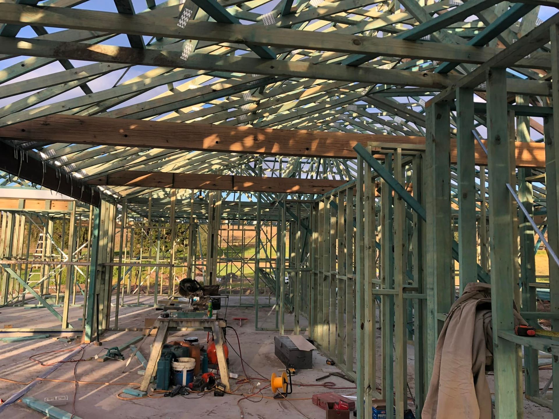 A Man is Working on the Roof of a House Under Construction — Trussted Frames & Trusses In Armidale, NSW