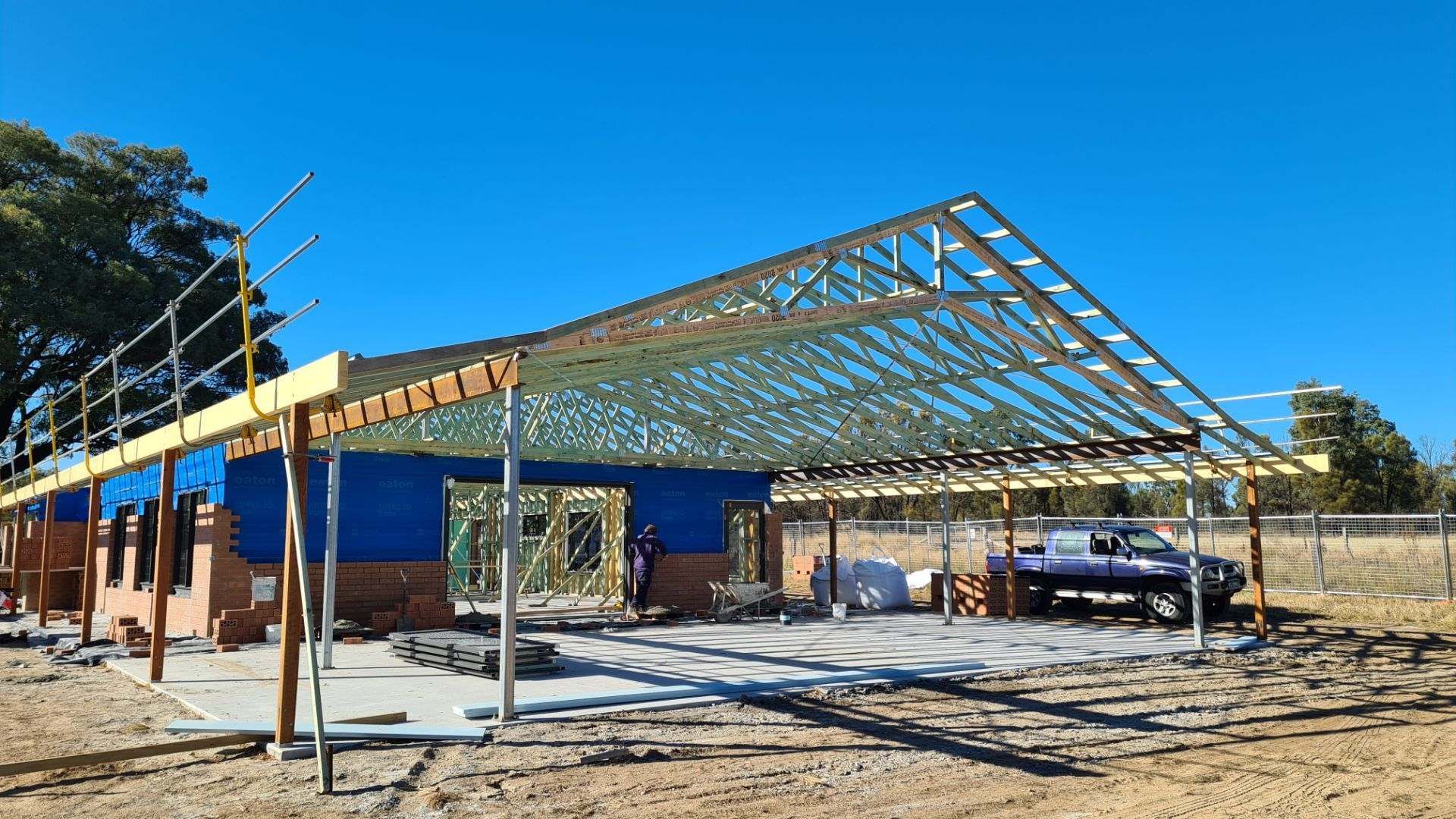 A Group of Construction Workers Are Working on a Building Under Construction — Trussted Frames & Trusses In Armidale, NSW