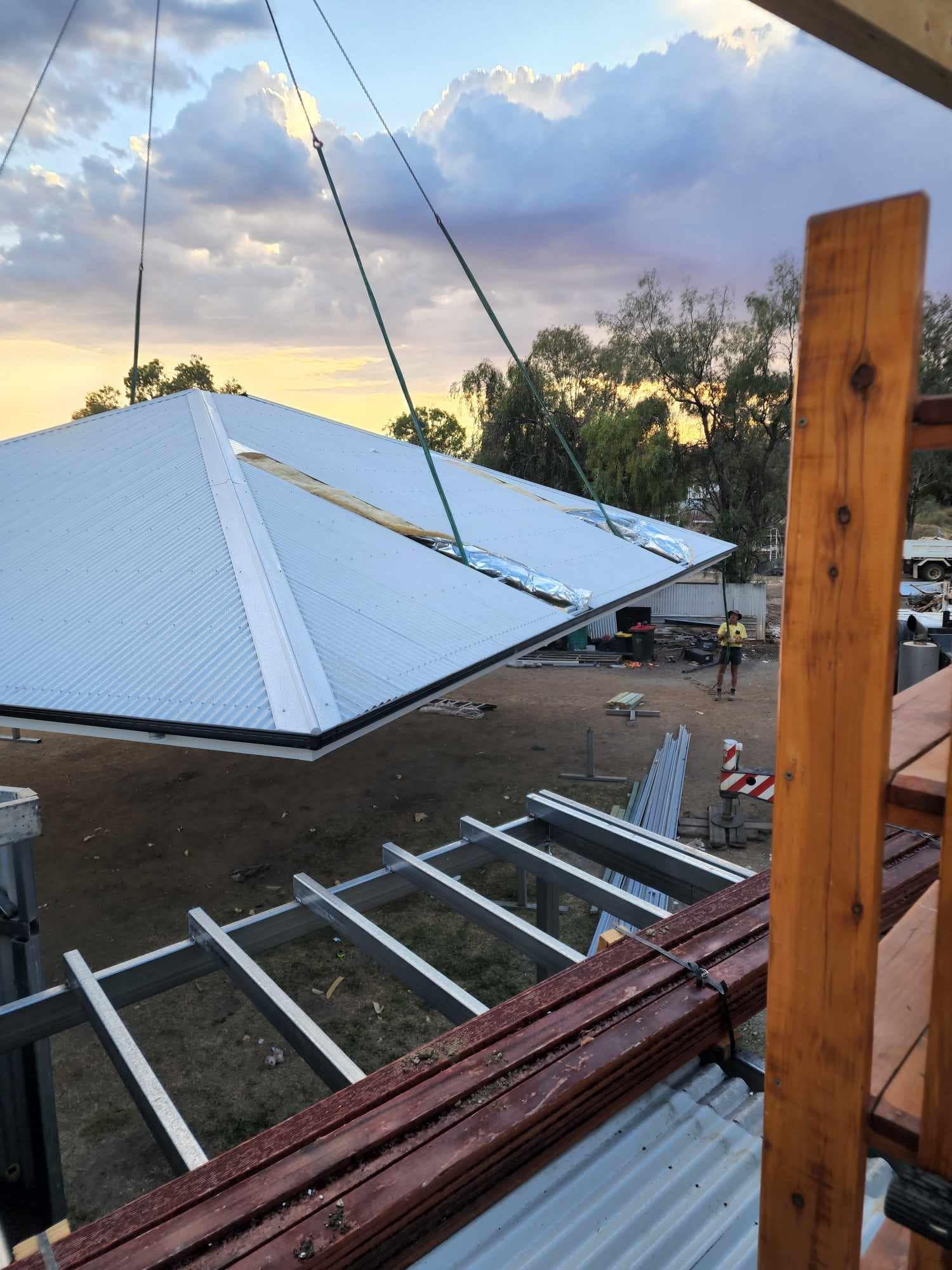The roof of a house is being built with wooden beams — Trussted Frames & Trusses In Armidale, NSW