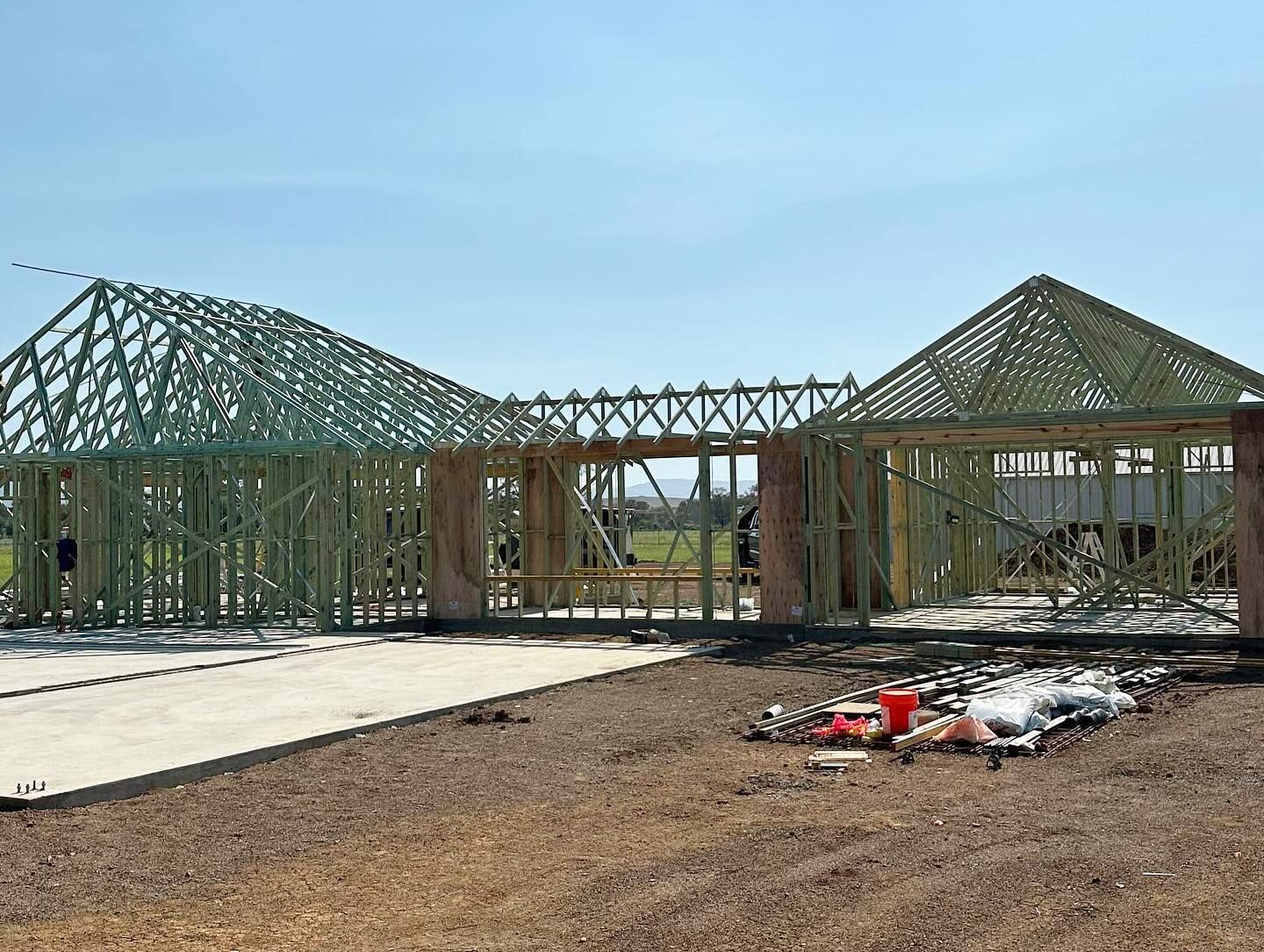 A Car is Parked in Front of a Building Under Construction — Trussted Frames & Trusses In Taminda, NSW