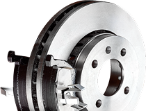 A close up of a brake disc on a white background.