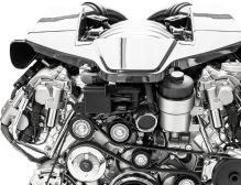 A close up of a car engine on a white background.