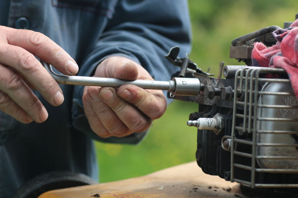 Hands Using A Wrench To Work On A Small Engine — Jack Too You Mobile Servicing and Repairs In Goomboorian, QLD