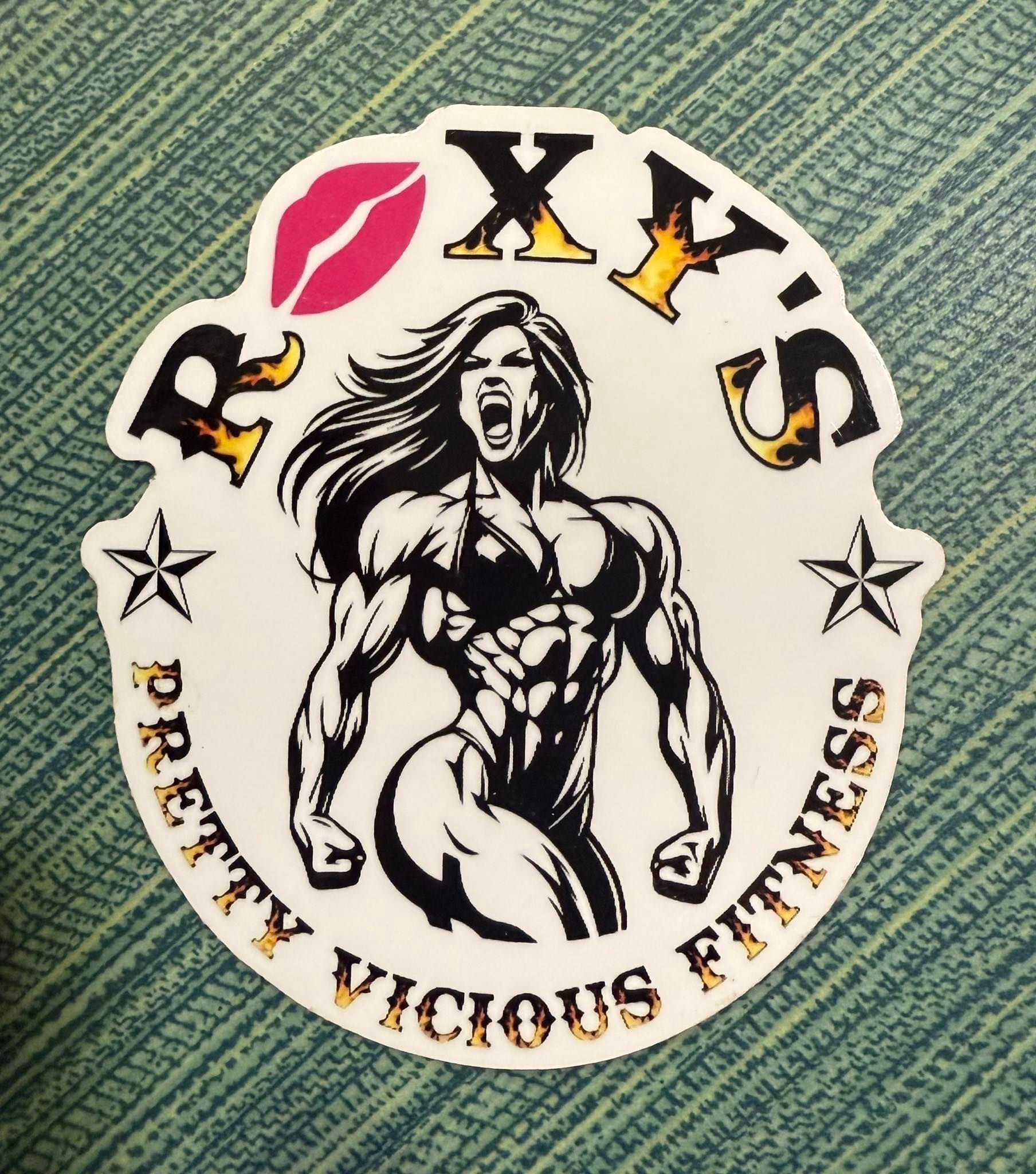 Logo for Roxy's Pretty Vicious Fitness featuring a muscular woman, a kiss, and text in gold.