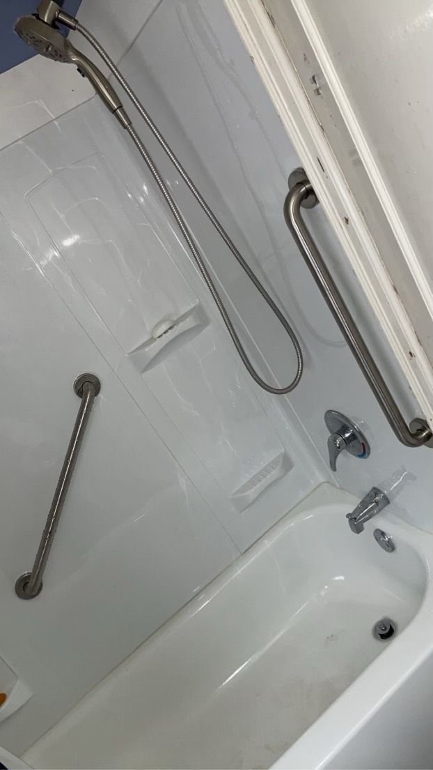 A Bathtub With A Shower Head And Handrails In A Bathroom — Philadelphia, PA — Edward Hughes & Son