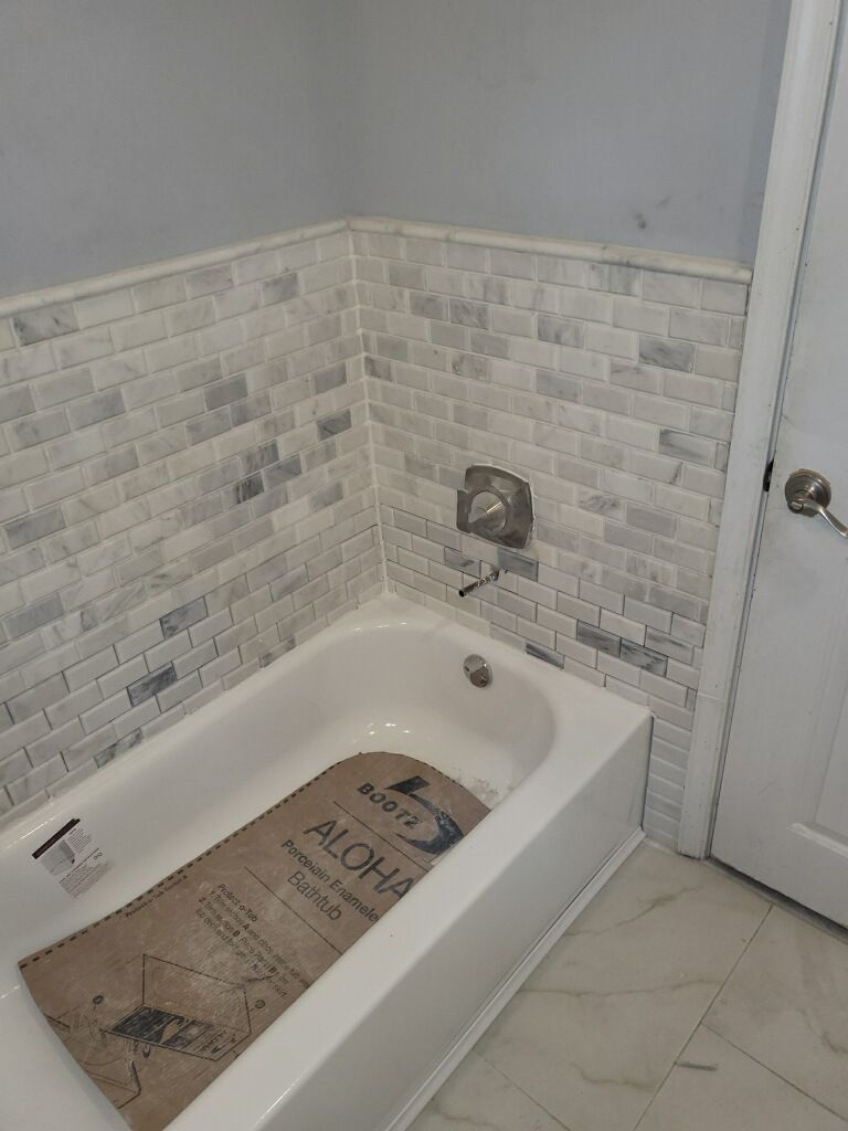 A Bathtub With A Rug On The Floor In A Bathroom — Philadelphia, PA — Edward Hughes & Son