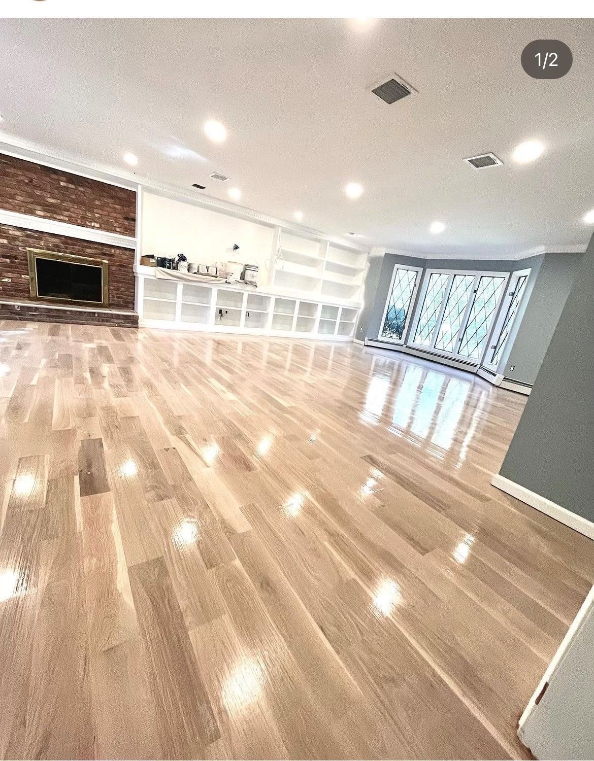 A living room with hardwood floors and stairs in a house.
